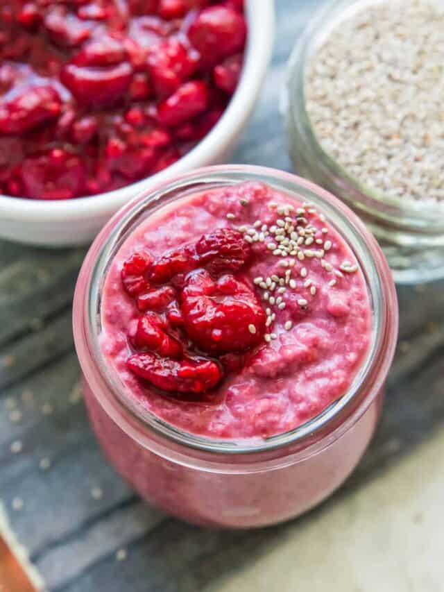 A glass jar with chia pudding in it with a few chia seeds sprinkled on top.