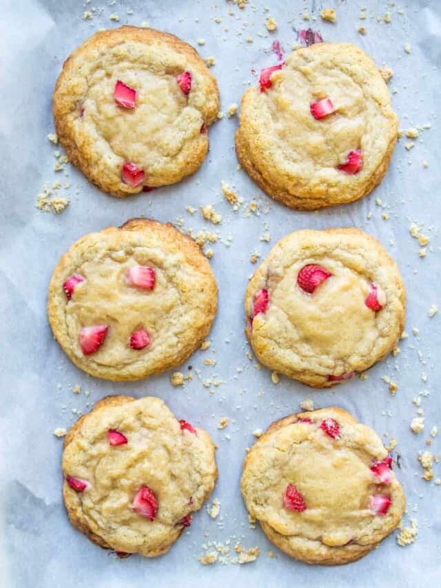 A baking sheet with strawberry cookies on it.