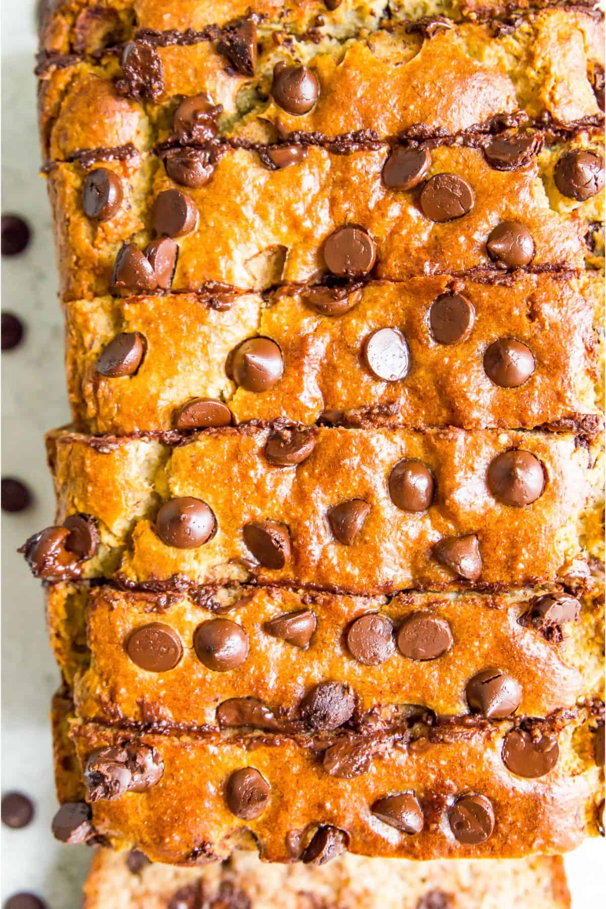 A loaf of chocolate chip banana bread cut into pieces.