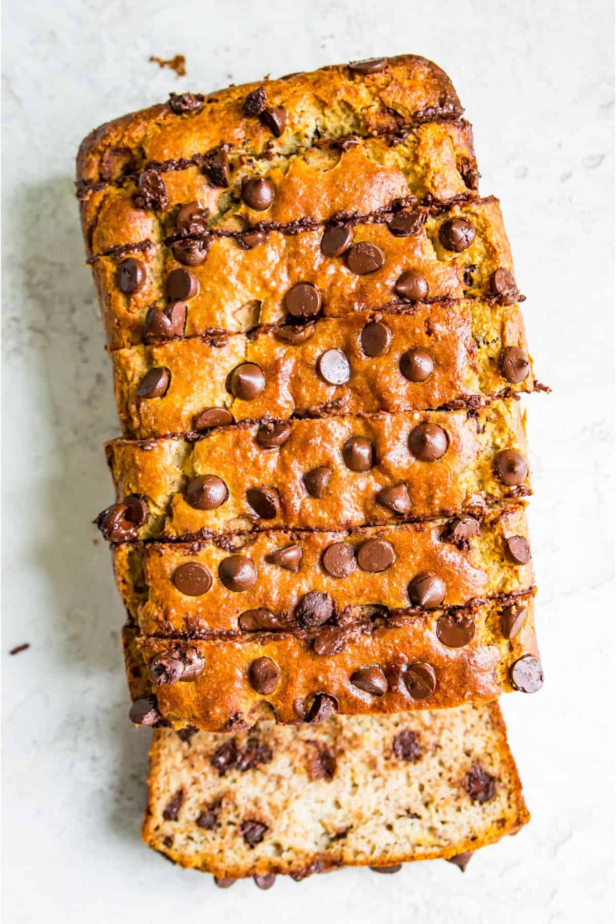 A loaf of gluten free chocolate chip banana bread cut into pieces. 