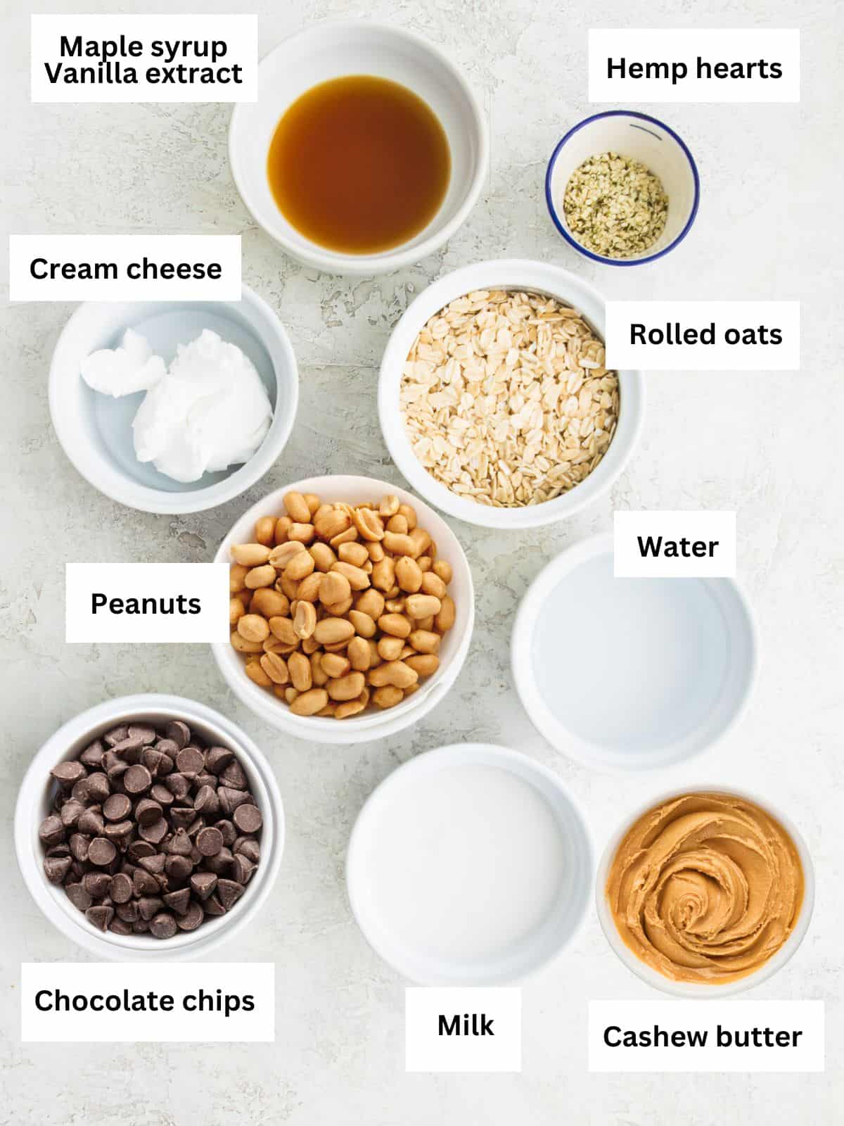 The ingredients needed to make snickers cheesecake overnight oats separated into small bowls. 