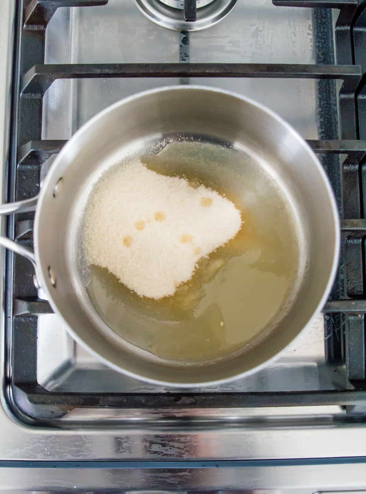 Icing sugar and lemon juice in a pot on the stovetop.