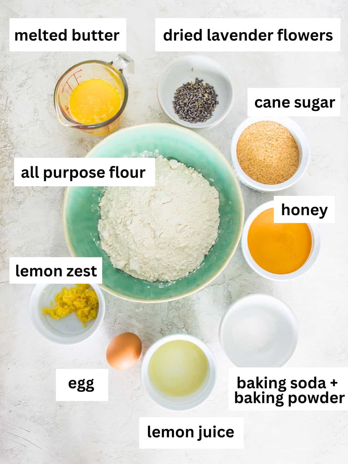 The ingredients needed to make lemon lavender cookies separated into small bowls. 