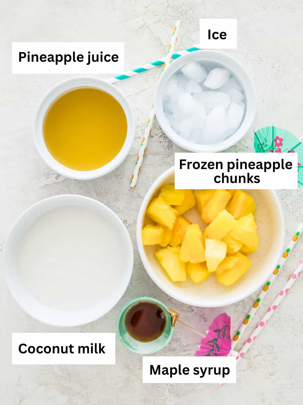The ingredients needed to make a piña colada mocktail separated into small bowls. 