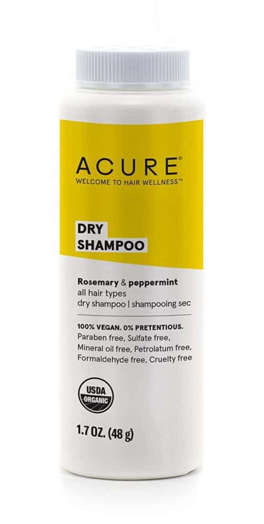 A bottle of Acure dry shampoo with a yellow label.