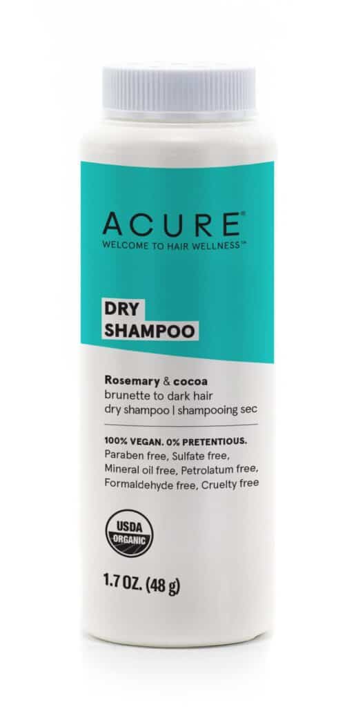 A bottle of Acure dry shampoo with a teal label.