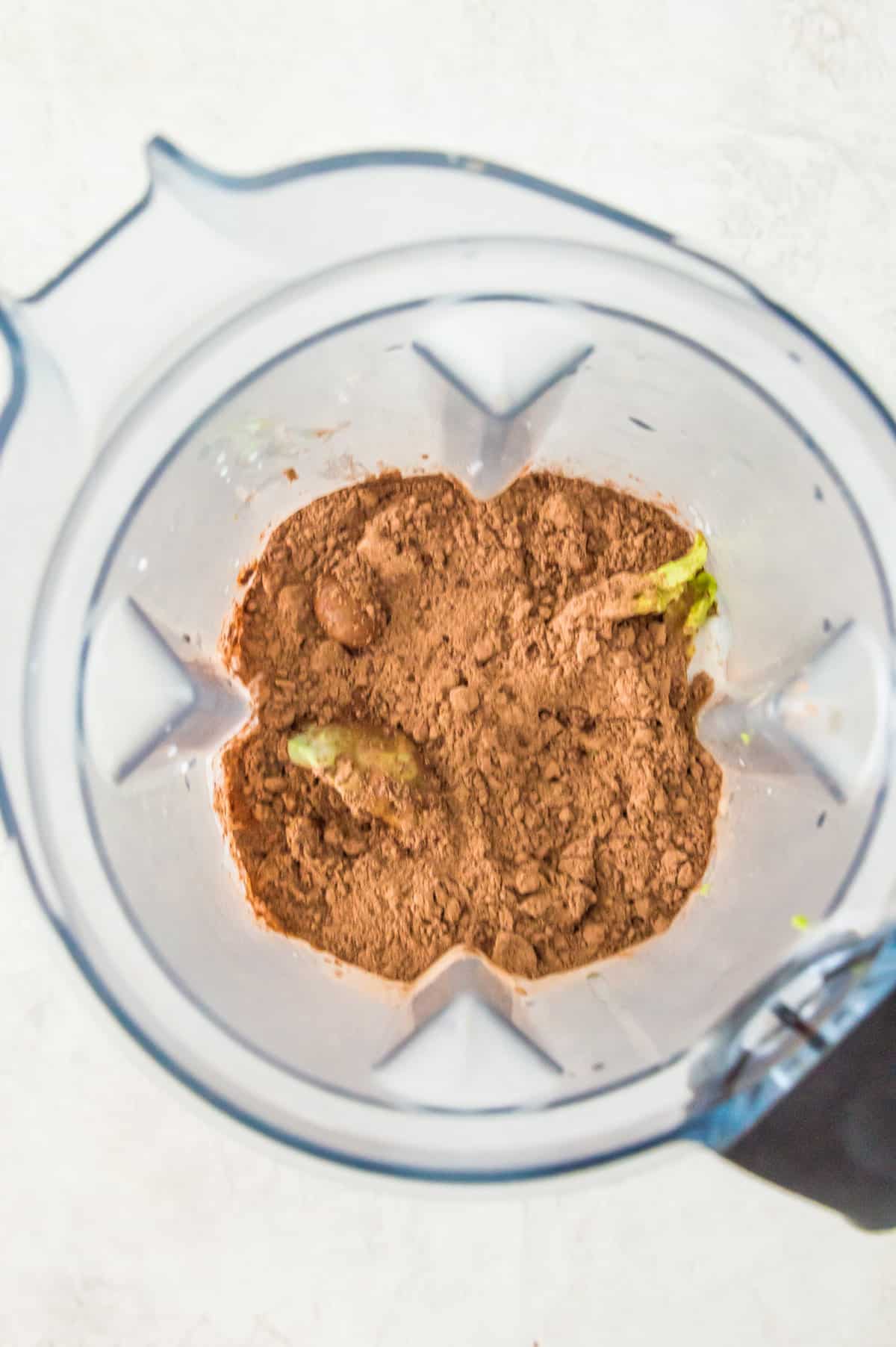 Cocoa powder and avocado in a blender.