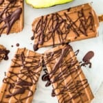 Avocado fudgesicles drizzled in dark chocolate on a serving tray.