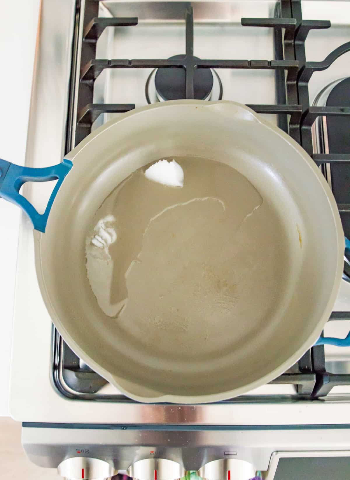 Coconut oil in a pan on the stovetop.