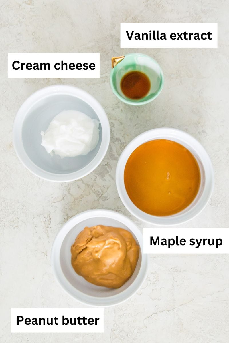 Four small bowls filled with vanilla extract, cream cheese, maple syrup and peanut butter.
