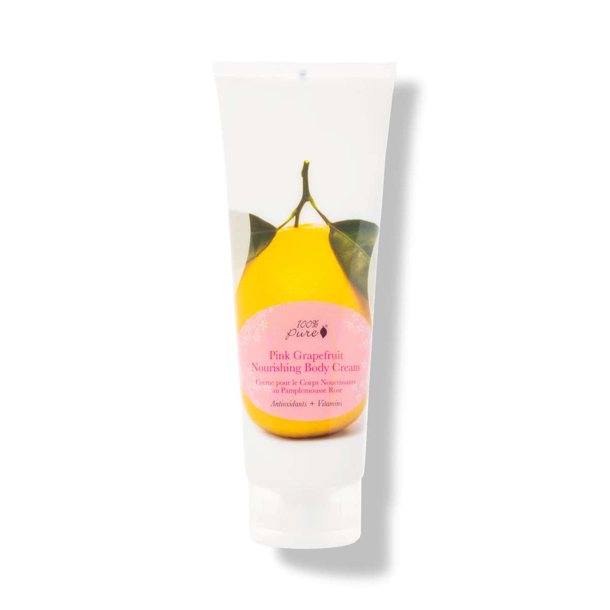 A bottle of 100% Pure body lotion with a grapefruit on it.