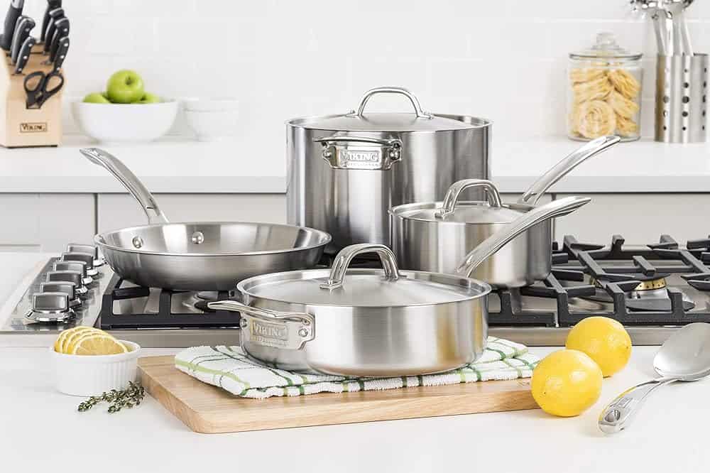 A set of Viking culinary professional stainless steel cookware including a large stock pot, 2 pans and a pot.