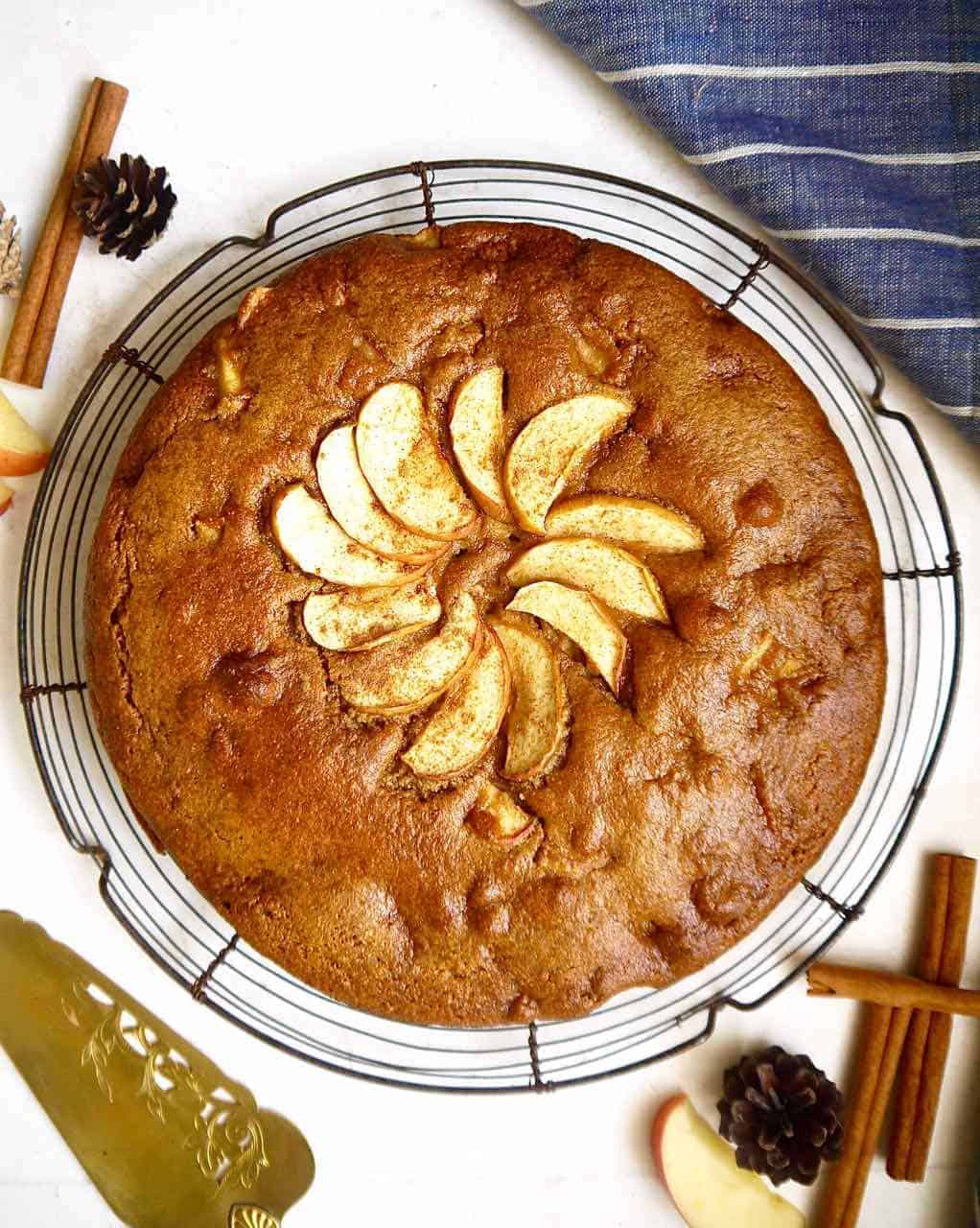 A paleo almond flour apple cake on top of a round cooling rack.