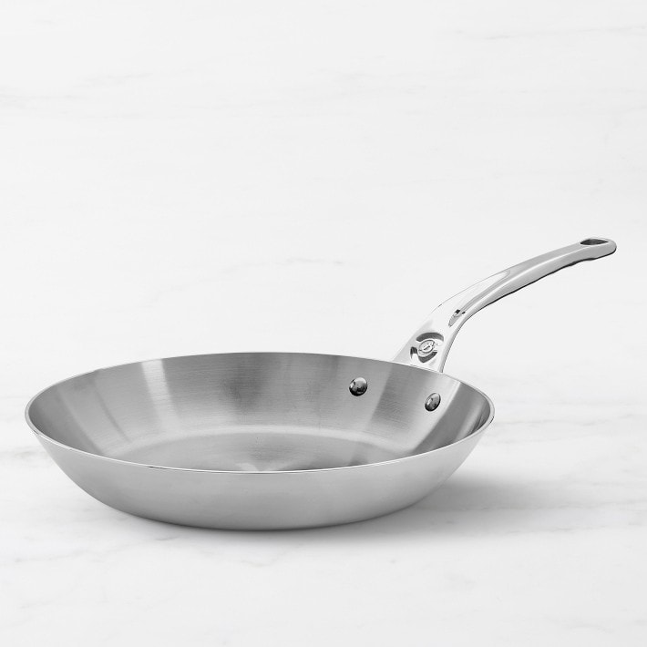 A De Buyer carbon steel frying pan on a white countertop.