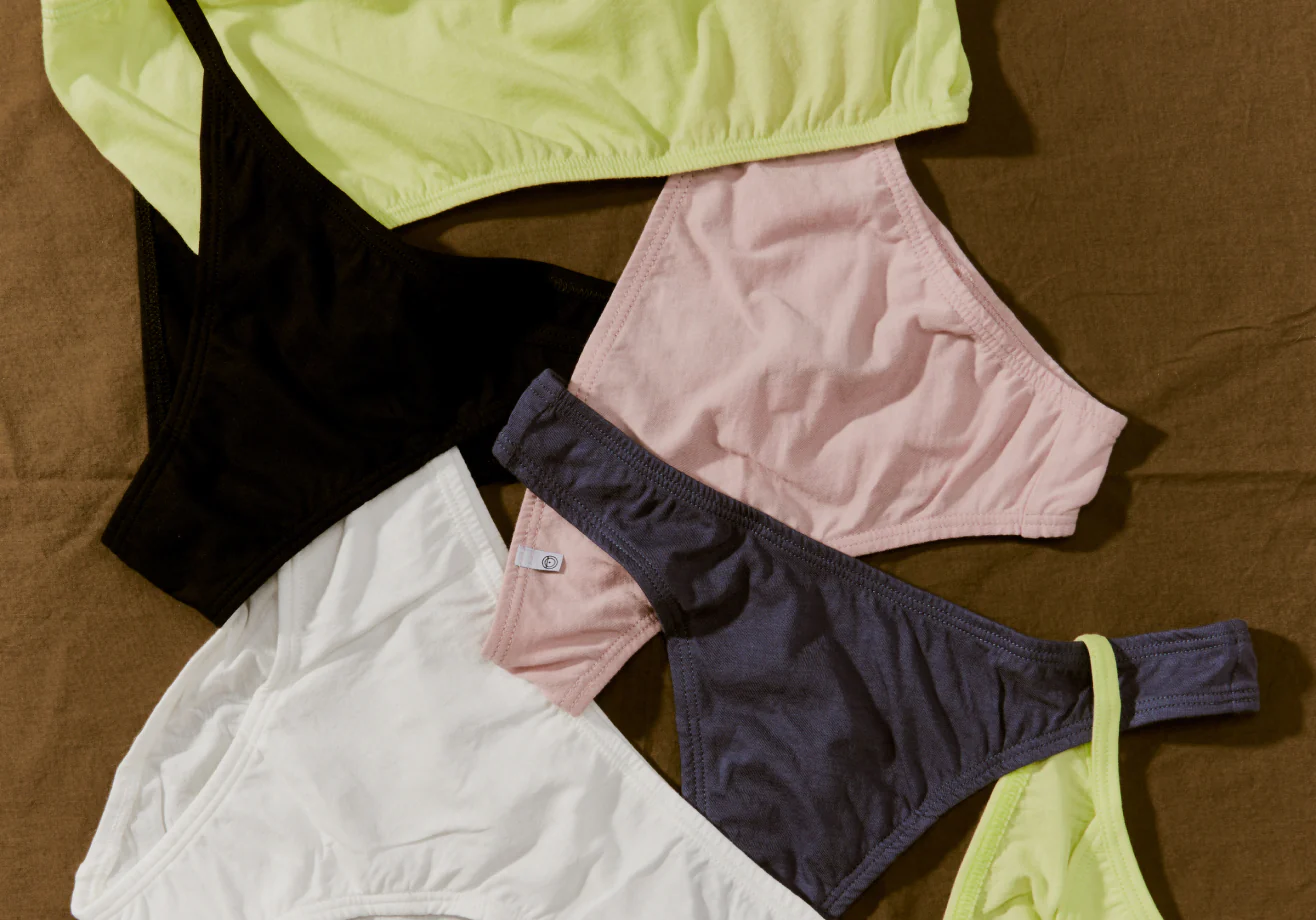 A pile of underwear in different colours including yellow, black, white and pink by the brand Oddobody.