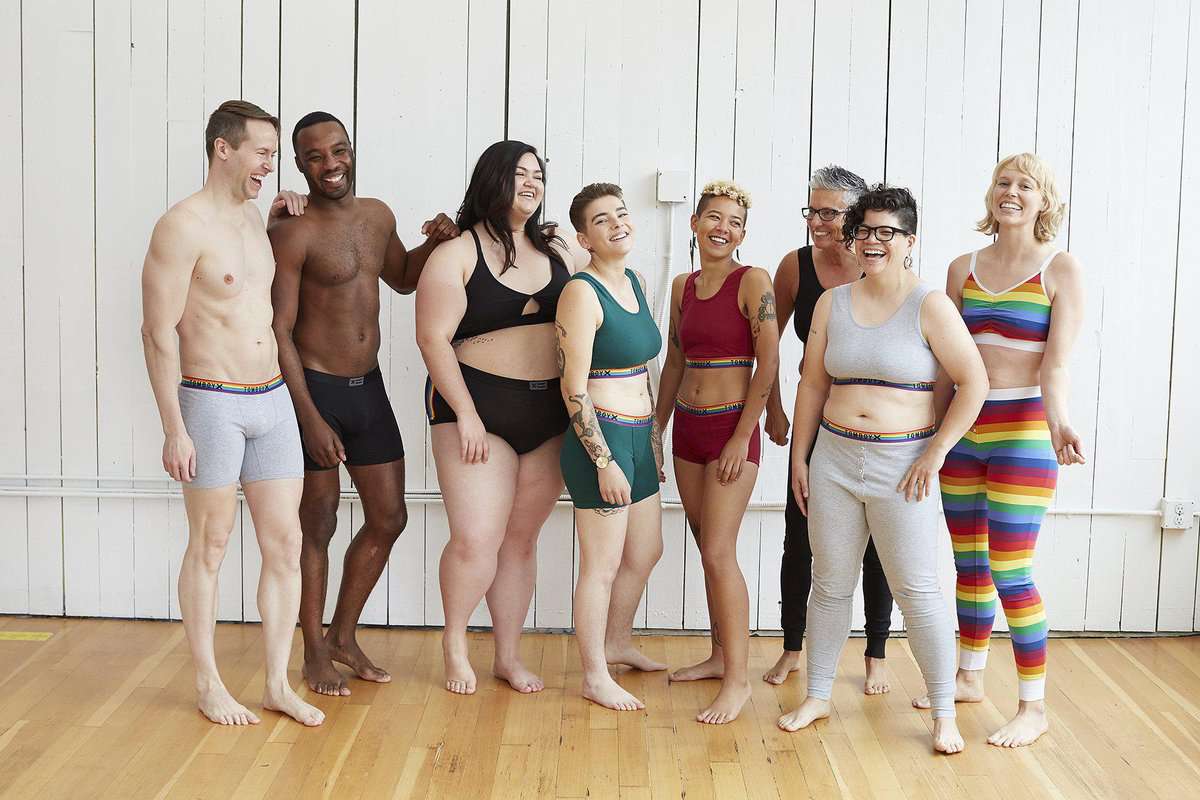 A group of women and men wearing bras, underwear and long johns in different colours and styles. 