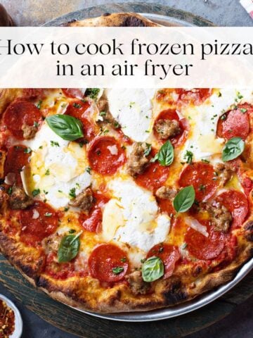 A cooked pizza topped with fresh basil, pepperoni slices and cheese with the title "how to cook frozen pizza in an air fryer" over it.