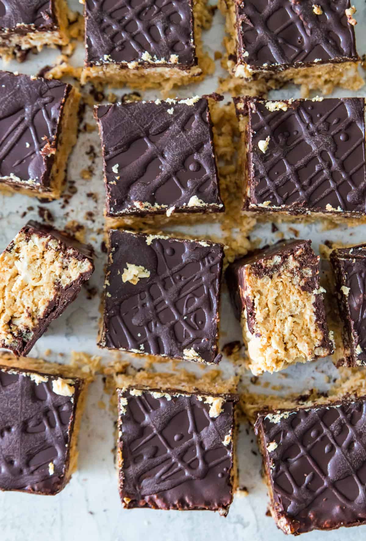A batch of chocolate covered Rice Krispie treats cut into squares.