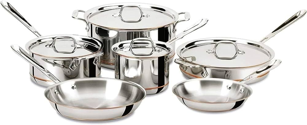 A set of stainless steel and copper pots and pans with stainless steel lids. 