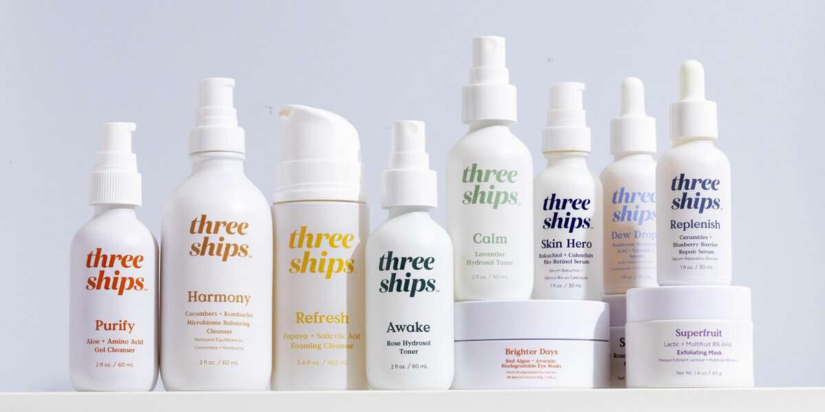 Many different bottles and tubes of Three Ships Beauty skincare products lined up next to each other.