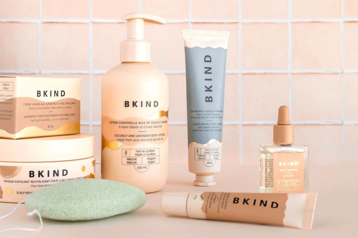 A bunch of different BKind brand skincare products including body lotion, face cream and body sponges.