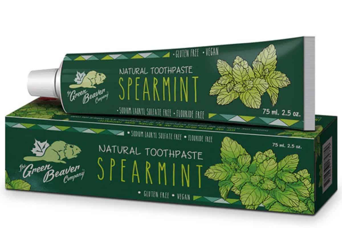 A green tube of Green Beaver toothpaste on a toothpaste box.