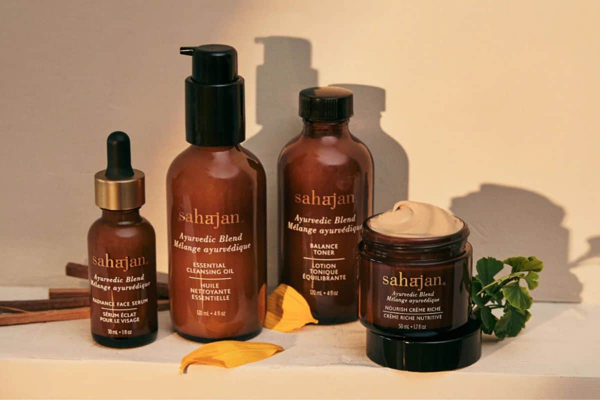 Glass jars and tubes of Sahajan brand skincare products.