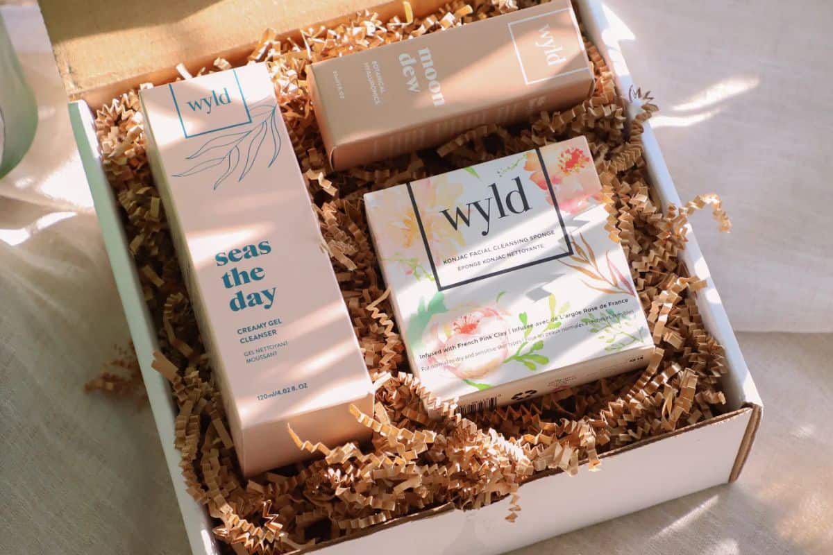 A cardboard box full of Wyld brand skincare products.